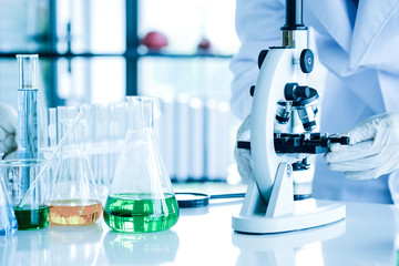 Scientists use a microscope Check for germs,Scientist with equipment and science experiments,Germ experts are working and testing in the lab.Research for vaccines to prevent disease concept