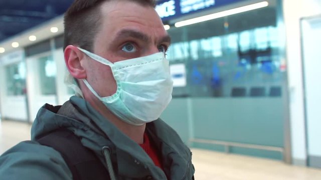 A volunteer in a medical mask examines an empty building while looking for infected people. Pandemic of a viral infection in Europe. Breathing protection.