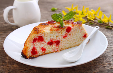 Cottage cheese casserole decorated with mint on a dark rustic background
