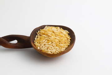 Pile lentil in wooden spoon isolated on white background. Top view.