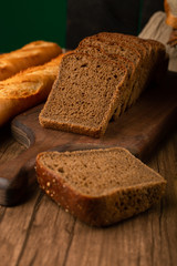 Slices of brown bread on kitchen board