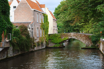 Fototapeta na wymiar Bridge and medieval houses over a canal in Bruges, Belgium. Colorful old house in european city. Bruges (Brugge), Belgium, Europe.