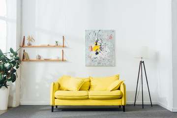 Interior of living room with yellow sofa and floor lamp