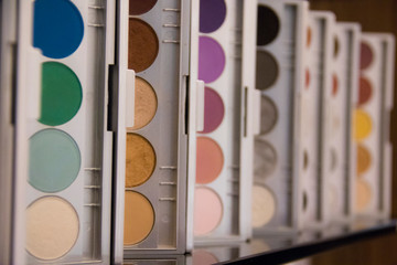 Row of eyeshadow makeup palettes