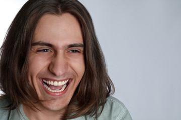 Portrait of happy young man on white background, closeup