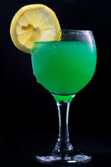 Cold green cocktail and lemon