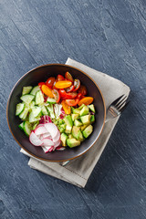 Vegan buddha bowl. Healthy vegetarian salad with cherry tomatoes, cucumber, radish, avocado, lettuce