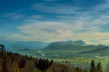 Dreamy blue landscape view of the forest and mountains in the background