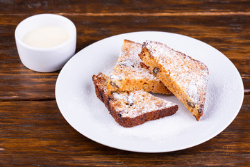 Cupcake with raisins and nuts, sprinkled with sugar powder