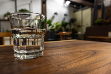A glass of water on a wooden table