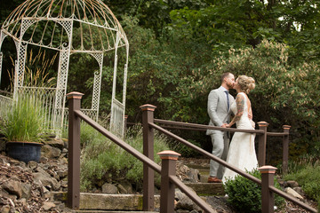 Bride and groom standing on path in nature setting wedding venue