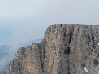 Clouds drift among the rocky cliffs.