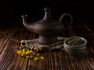 herbal tea in a ceramic bowl on a black background.