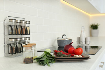 Naklejka na ściany i meble Fresh vegetables on white countertop in kitchen