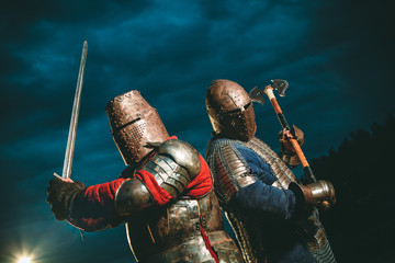 Two Medieval knights armed with axe and sword.