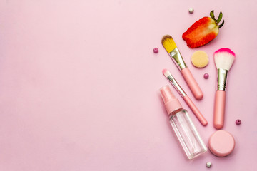 Fototapeta na wymiar Makeup cosmetic set on pink background