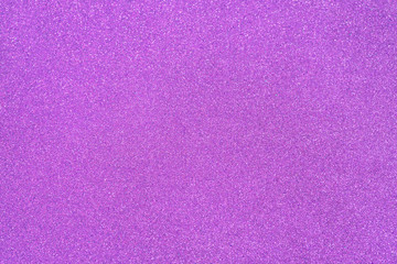 Violet orchid glitter twinkle abstract New Year or Christmas holiday background with sparkles. Modern luxury mock up with sequins. Texture of colored porous rubber with spangles