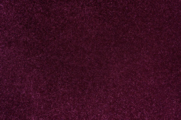 Dark magenta glitter twinkle abstract New Year or Christmas holiday background with sparkles. Modern luxury mock up with sequins. Texture of colored porous rubber with spangles