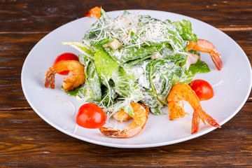 Salad with royal shrimp, lettuce leaves, parmesan cheese