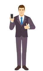 Smilig Businessman holding mobile phone and shows thumb up. Full length portrait of Businessman in a flat style.