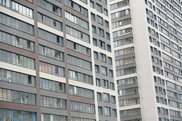 Frontal view of facade of building with a lot of windows.