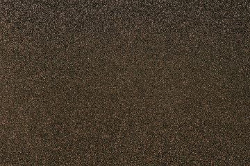Brown black glitter twinkle abstract autumn or Christmas holiday background with sparkles. Modern luxury mock up with sequins. Texture of colored porous rubber with spangles