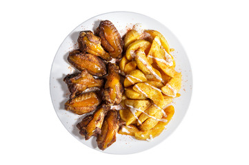 Fried chicken wings with fried potatoes with sauces and red pepper powder