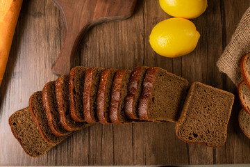 Brown bread with lemons on tablecloth