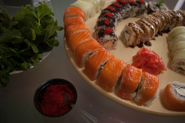 seafood, salmon sushi rolls with vegetables and sauce