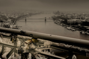 Fototapeta na wymiar Locks for love on a railing in Budapest over the Danube river in winter