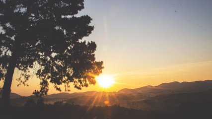 Fototapeta na wymiar sunrise on horizontal line of mountain for waking