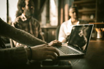 Male Hands Typing At Laptop During Business Meeting, Caucasian Man Working With Notebook, Selective Focus On Computer Keys, Side View, Business Team On Blurred Back