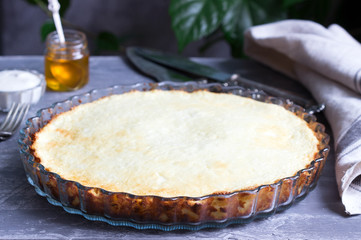 Diet cottage cheese casserole with lemon zest and vanilla, served with sour cream and honey.