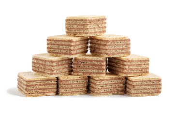 Pile of square wafer biscuits in shape of pyramid isolated on white