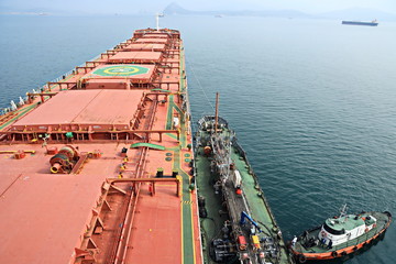 Bunkering of a ship on the open roadstead of the port of Nakhodka, Russia.