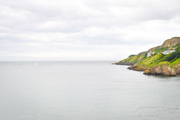 Howth island on ireland, near dublin. cloudy sky and green island, perfect place for hiking and...