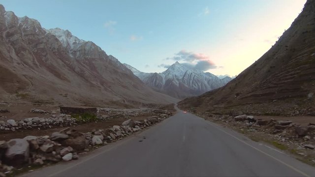 Driving car on Karakoram highway Pakistan mountains road in autumn having brown color mountains on both sides