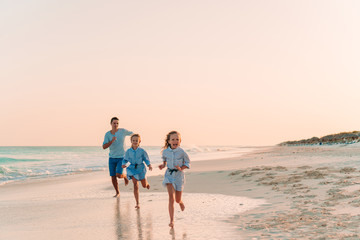Happy beautiful family on a tropical beach vacation