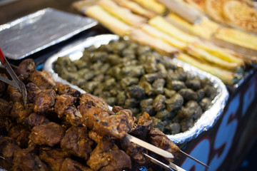 Street food counter with meat and vegetables