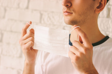 Closeup of young doctor wearing face mask for protection