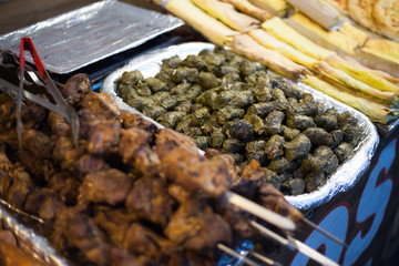 Street food counter with meat and vegetables