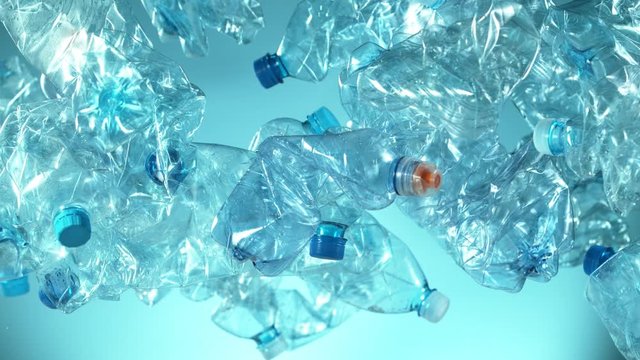 Super slow motion of empty plastic bottles flying into the air. Filmed on high speed cinema camera, 1000 fps.