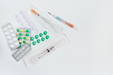 medicines in a package and a syringe