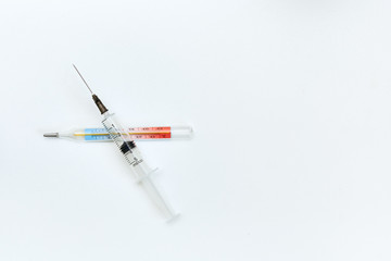 syringes lies on a thermometer