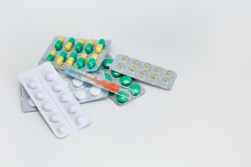 packaging with medicines and pills thermometer