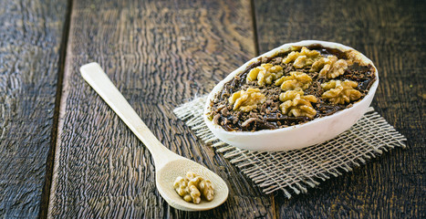 Chocolate egg and walnuts with filling for Easter on wooden background. Brazilian Easter egg, Brazilian tradition.