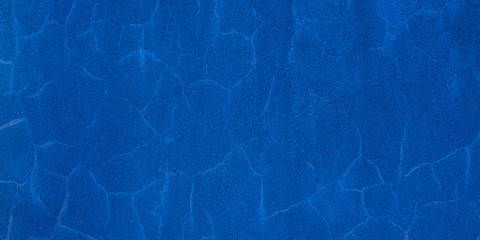 Grunge blue classic concrete cement wall with crack texture background