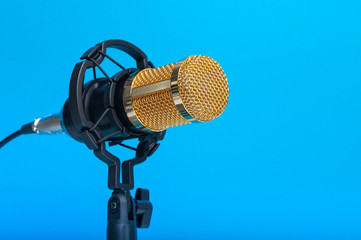  Studio microphone for recording podcasts, songs, and radio programs on a blue background with a...