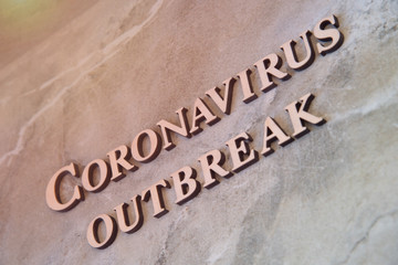 coronavirus outbreak word written on wooden letters.