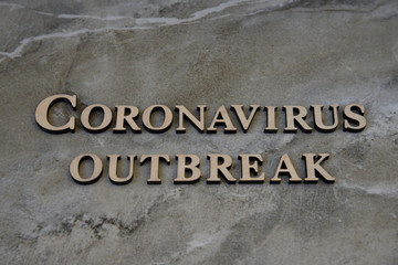 coronavirus outbreak word written on wooden letters.